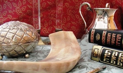 Judaica (clockwise from top): Shabbat candlesticks, handwashing cup, Chumash and Tanakh, Torah pointer, shofar, and etrog box CC: Wikipedia