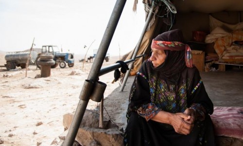 A resident of the village of Khirbet al Fakheit gazes from her tent, October 17, 2012. This village of nine families is one of the eight Palestinian communities slated for demolition in the area of the South Hebron Hills designated by the Israeli military as "Firing Zone 918". The residents of the villages, assisted by Israeli human rights organizations, are resisting the demolition through legal battles. Ryan Rodrick Beiler/Activestills