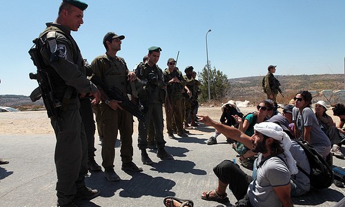 Demonstration against the Wall in Al Walaja, 27.06.2011 A group of Palestinians, Israelis and internationals demonstrate in front of Har Gilo settlement in the village of Al Walaja following this week decision of the Israeli Supreme Court to reject petition of Al Walaja residents to change the route of the Wall, 27.06.2011. The march to the settlement was stopped by Israeli soldiers. Four Israeli activists were arrested. Photo by: Anne Paq/Activestills.org