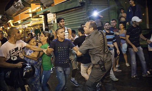 “Today Ruth Would be Considered an Infiltrator and Forbidden from Gleaning “| Police attempting to contain a mob on an anti-African spree after a protest against African refugees and asylum seekers in Tel Aviv’s Hatikva neighborhood on May 23, 2012. Photo by: