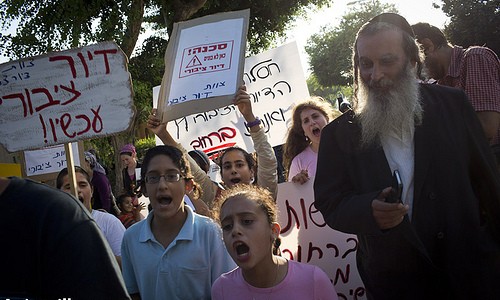 Members of the Shabi family and actvists protest for public housing and to show solidarity with the Shabi family, which was evicted from her house and now lives in a park, in the city of Petach Tikva, July 23, 2013. Photo by: Oren Ziv/ Actviestills.org